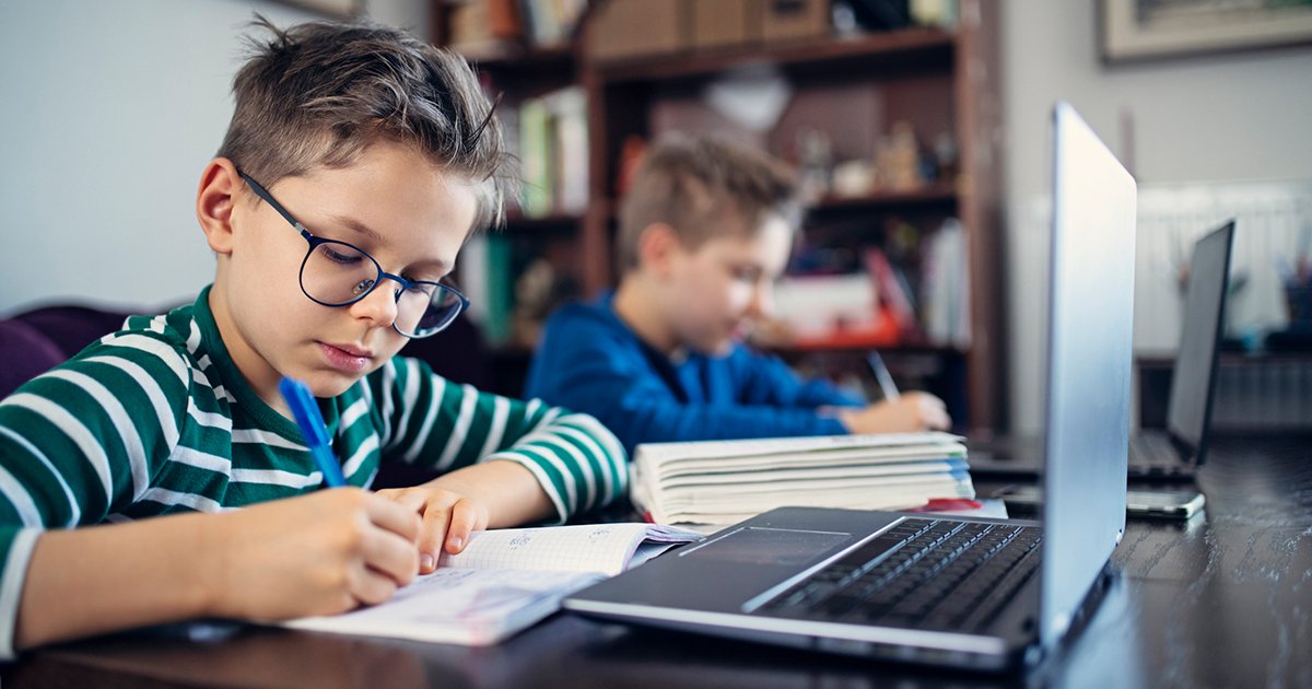 Blog-hero_keeping-kids-connected-to-class_two-boys-writing-and-studying-at-home-at-the-kitchen-table_facebook-2
