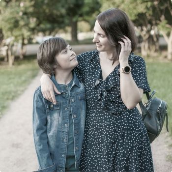 Mother and Son walking and talking in a park